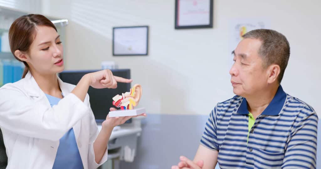 Man receives education about ear from doctor