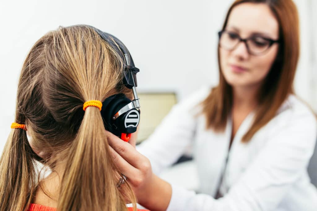 Young girl taking a hearing test.