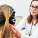 Young girl taking a hearing test