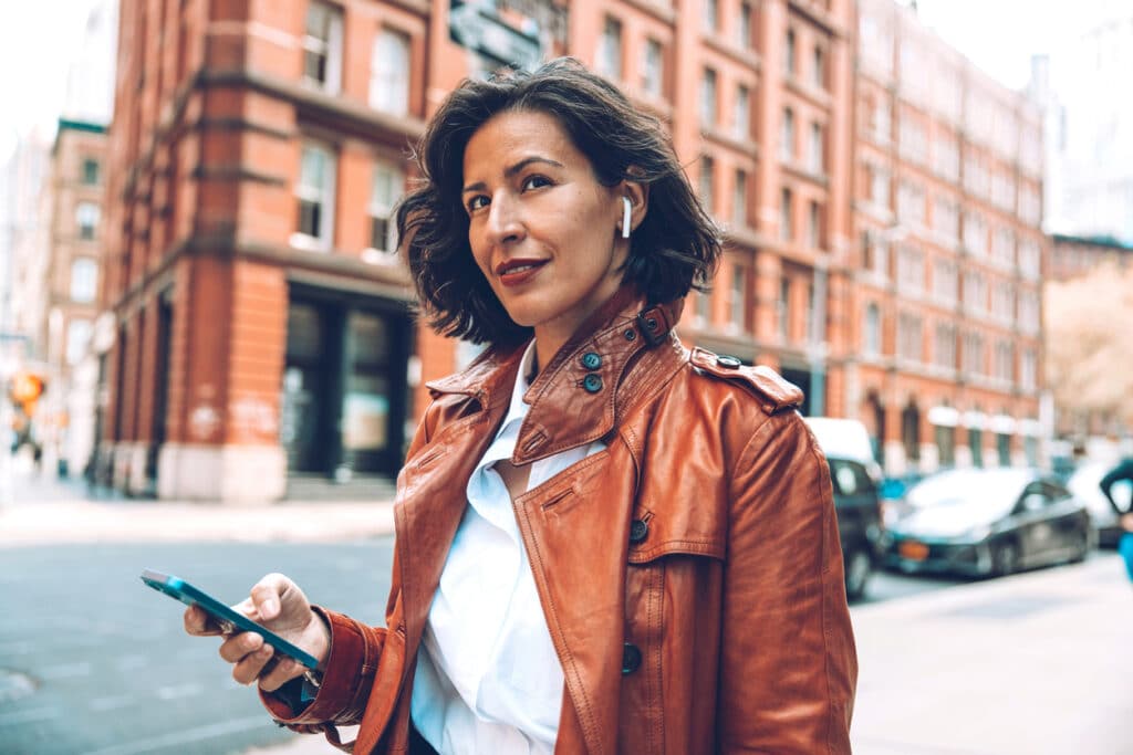 Woman wears headphone in city