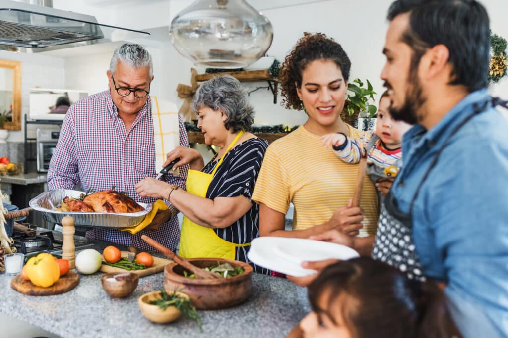 Family preparing Thanksgiving dinner together.