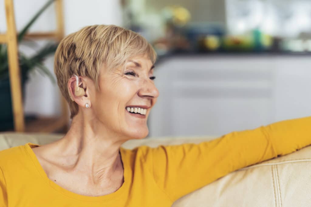 Happy senior woman with a hearing aid