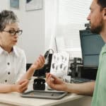 Audiologist discussing hearing aid options with her patient