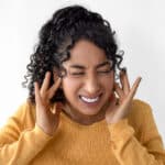 Woman frustrated and fingers in ears