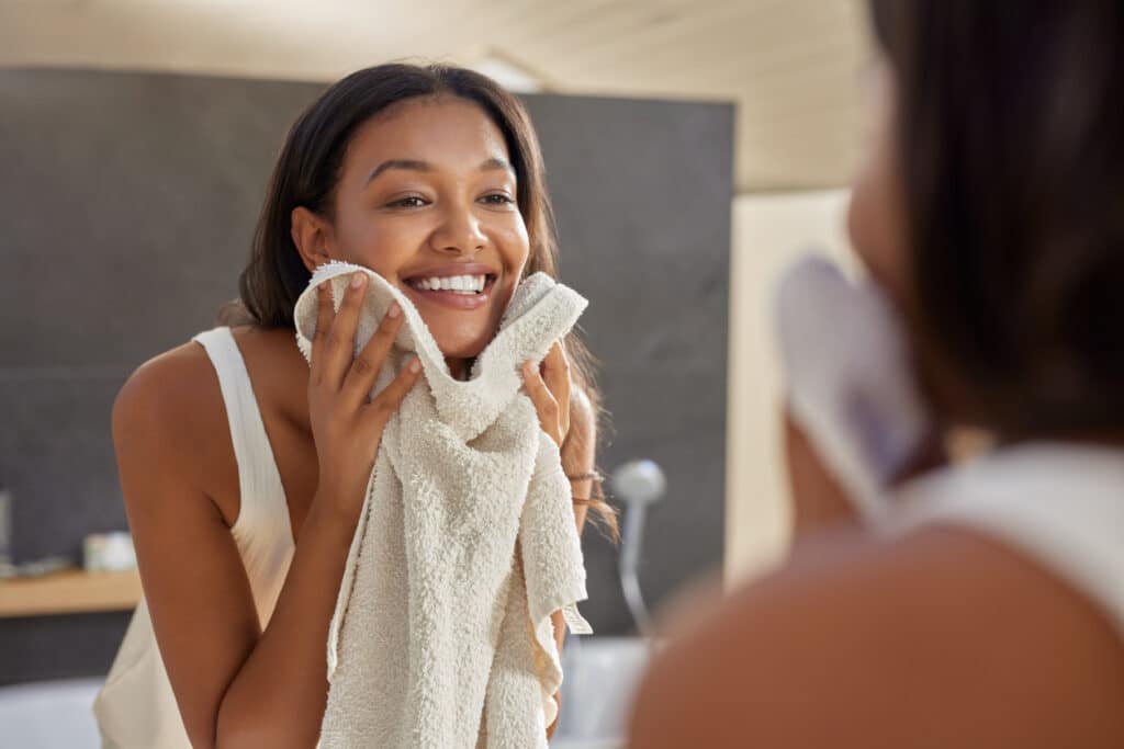 Woman washing face during morning skin care.